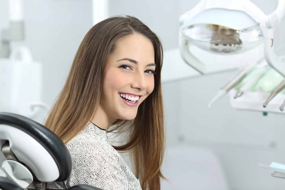 a dental patient smiling after her cosmetic treatment