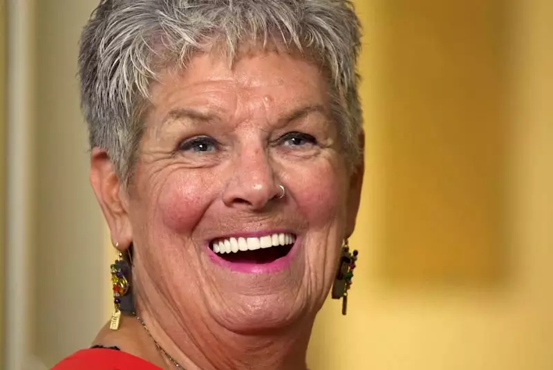 A patient with a big smile showing the dental implant work done by East Bay Healthy Smiles.